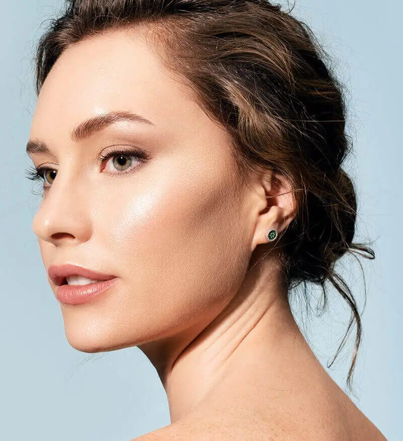 Woman in three-quarter profile with her hair swept up, showing her jawline and neck