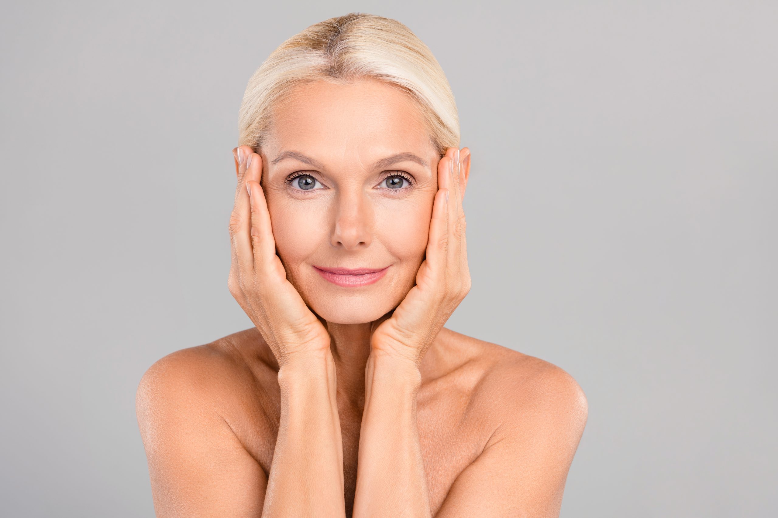 Mature woman touching her face