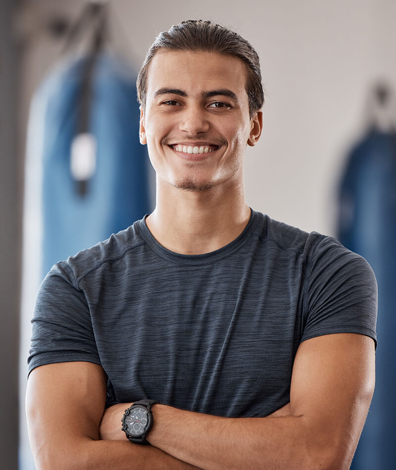 Man with his arms crossed smiling