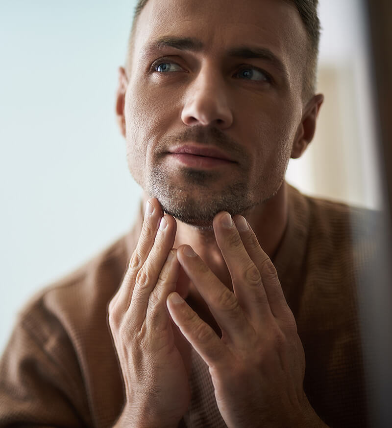 Man looking at himself in the mirror