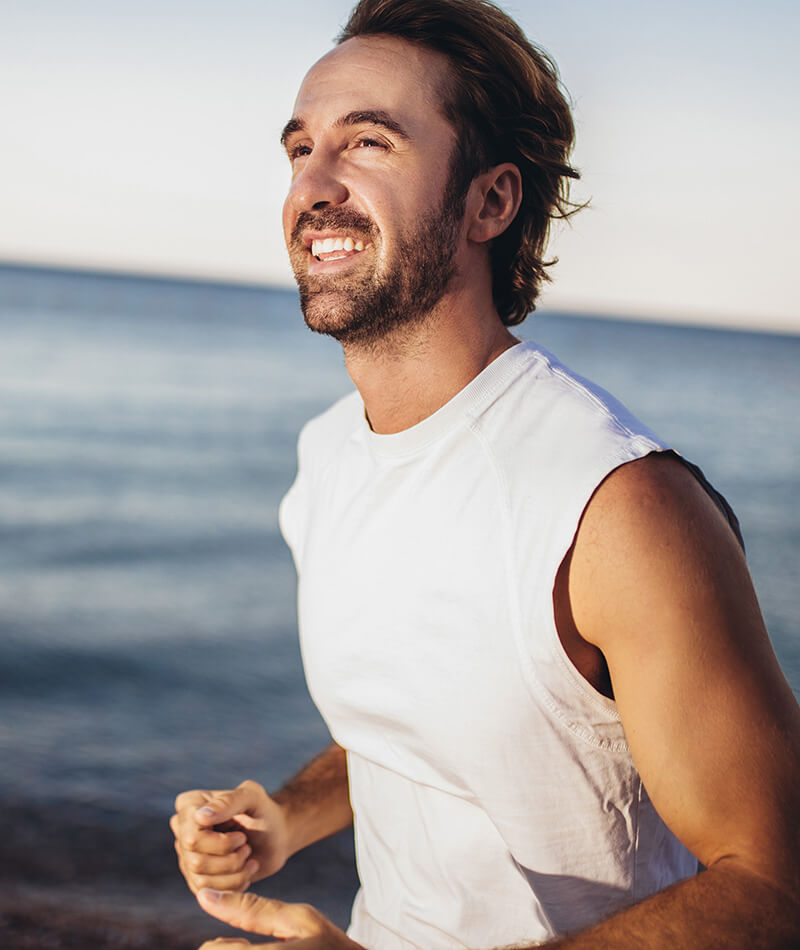 fit man jogging on the beach