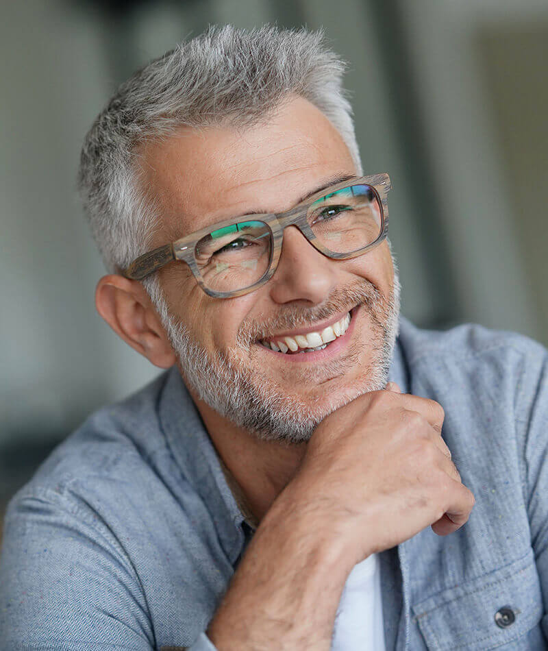 Man with glasses smiling