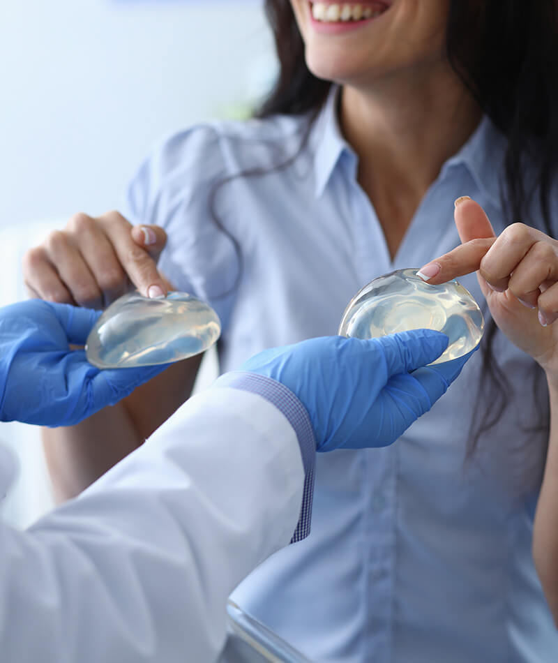 Woman choosing implants with a doctor