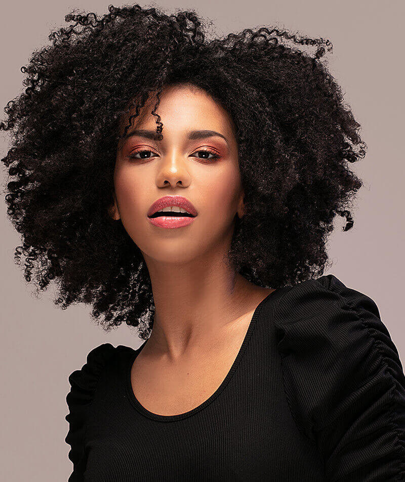 young woman with black curly hair