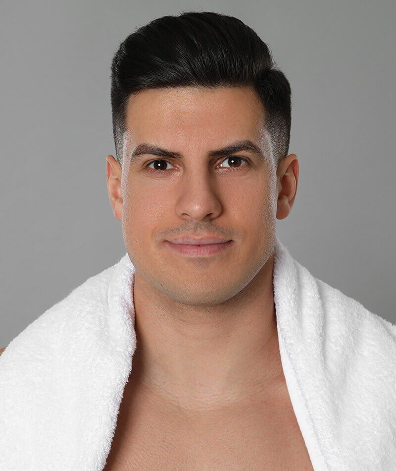 Young man with a towel around his neck