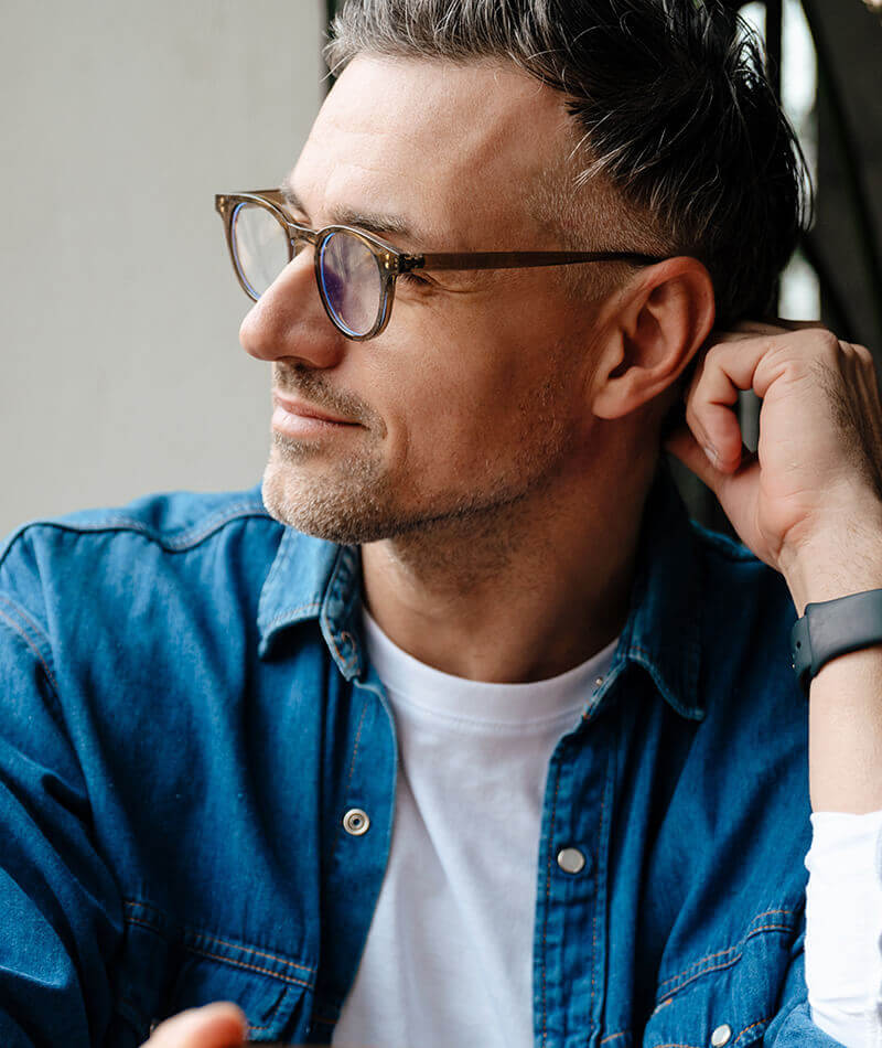 Man in a blue shirt with glasses